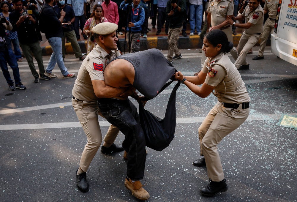Security personnel detain a protester in Delhi on Saturday (Reuters)