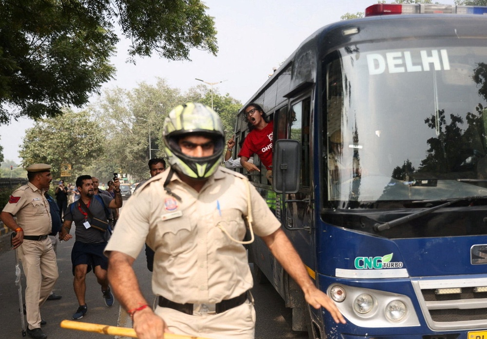 Neha Bora, leader of the All India Students' Association, shouts from a police vehicle after being detained in Delhi on Saturday (Reuters)