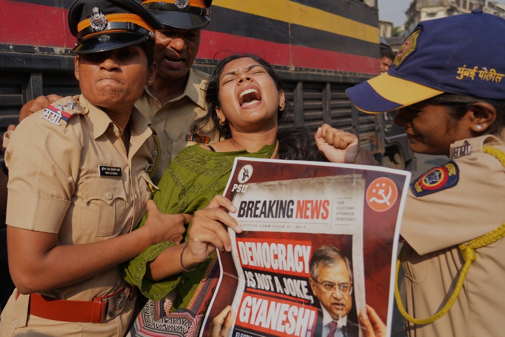 Police detain a protester in Mumbai on 10 October 2026 (AP)