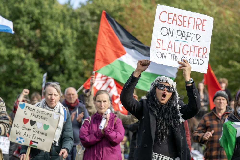 Many of the demonstrators carried flags and signs (Lesley Martin/PA) (PA Wire)