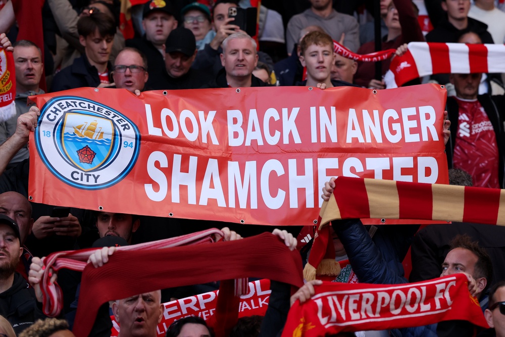 Liverpool fans display a banner at Anfield (Getty)