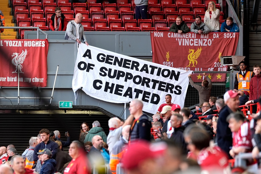 A banner is displayed with the words 'A generation of supporters cheated' by Liverpool fans before their match with Man City (PA)