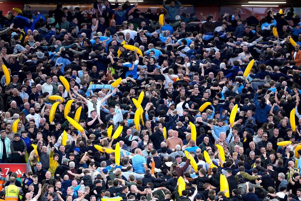City fans hold up bananas during the match at Anfield (PA)