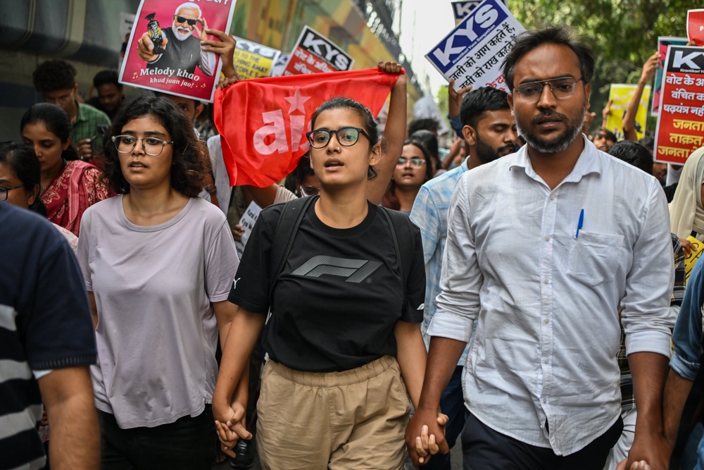 All India Students Association president Neha Bora, wearing a black shirt, takes part in a march during a protest on 11 October 2026 (Getty)