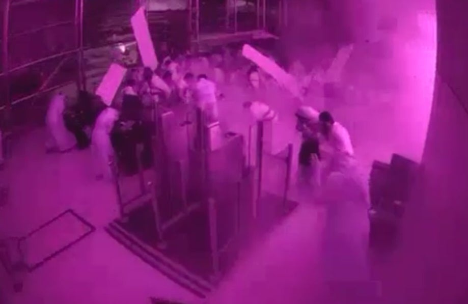 This image from CCTV video released by Saudi Arabia's Media Ministry shows passengers taking cover as flames and smoke fill part of King Khalid International Airport in Riyadh, Saudi Arabia, during what authorities described as a strike at the airport on Saturday, 10 Oct 2026 (Saudi Media Ministry)