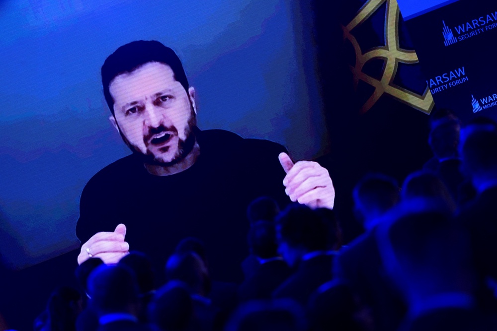 Ukraine's president Volodymyr Zelensky appears on screen as he speaks during the Warsaw Security Forum (Reuters)