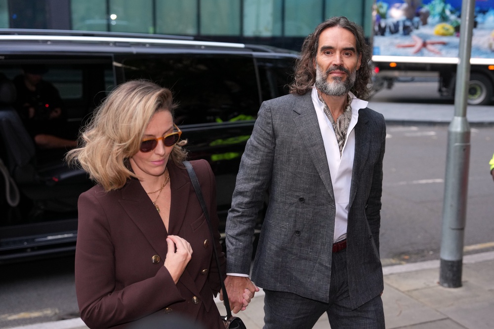 Comedian and actor Russell Brand, accompanied by his wife Laura Brand, arrives at Southwark Crown Court (AP)