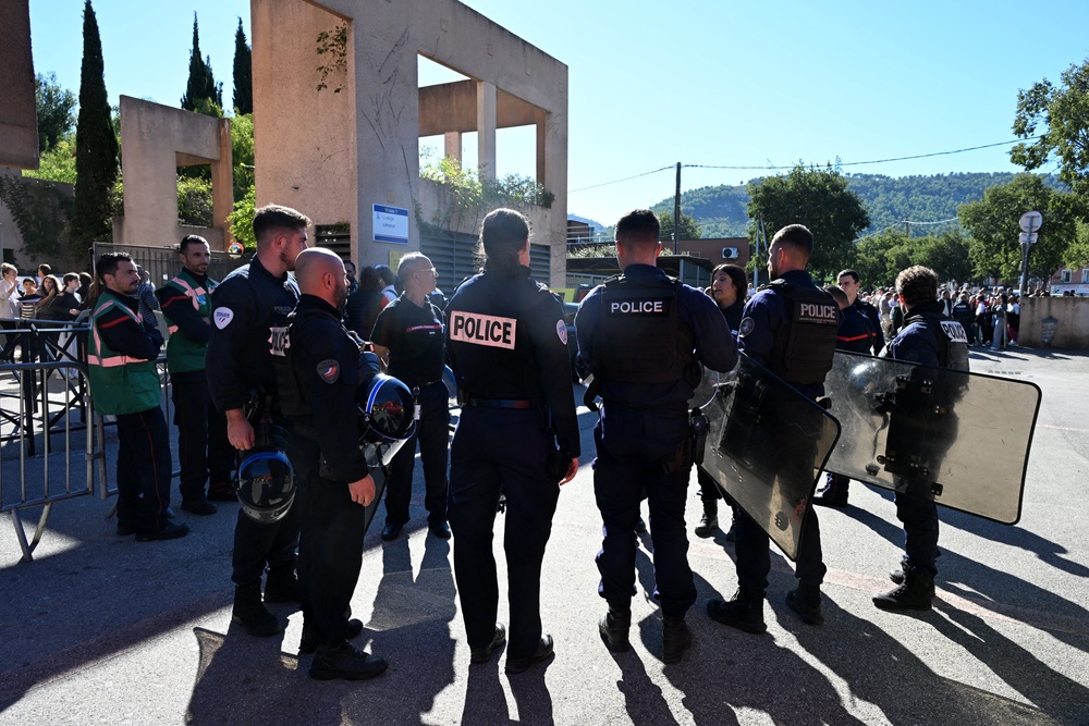 Policemen stand in front of Joseph-Lakanal high school after a headmaster was injured by a hunting rifle shot and a teenager was arrested in Aubagne, southern France, on October 12, 2026. (AFP/Getty)