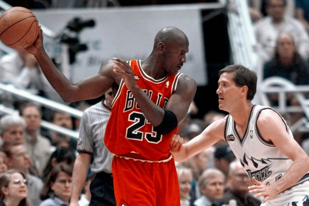 Chicago Bulls' Michael Jordan pulls the ball out of reach of Utah Jazz guard Jeff Hornacek during third quarter action in Game 2 of the NBA Finals in Salt Lake City (AP Photo/MARK J. TERRILL)