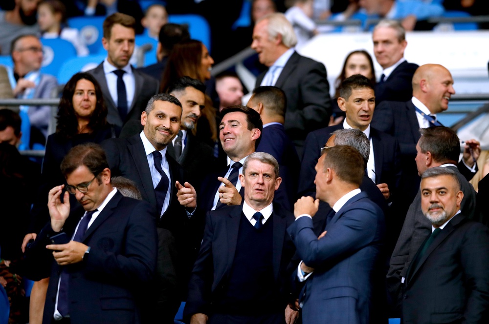 Andy Burnham and Khaldoon Al Mubarak spoke while watching the Vincent Kompany testimonial game at the Etihad Stadium (Martin Rickett/PA) (PA Archive)
