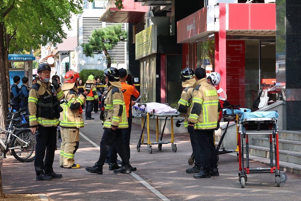 South Korean police officers and firefighters are mobilized outside of a shopping mall in Incheon, South Korea (AP)