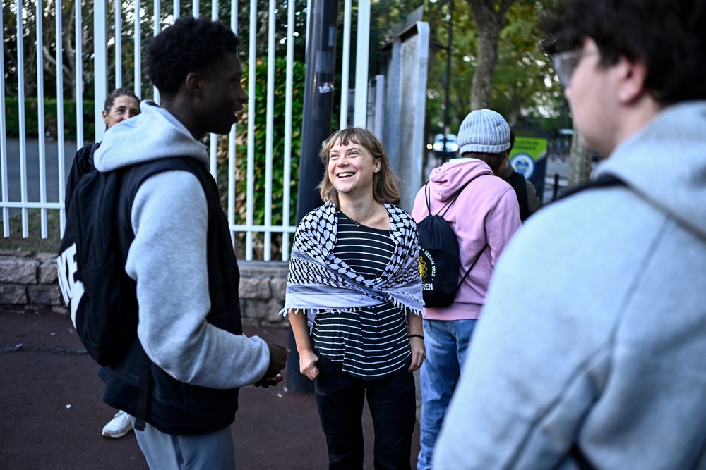 Swedish activist Greta Thunberg speaks with students as they prepare to take part in a blockade at the Lycee Paul Eluard in Saint-Denis, on the outskirts of Paris on October 13, 2026 (AFP/Getty)