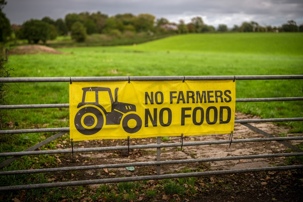 A banner declaring 'No Farmers No Food' hangs from a farm gate in the Cheshire countryside (Getty)