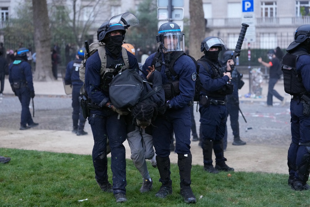 Police officers detain a protester during a demonstration of high-school students in Paris (AFP/Getty)