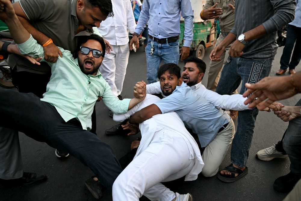 Police detain protesters during a demonstration chief election commissioner Gyanesh Kumar’s resignation (AFP/Getty)