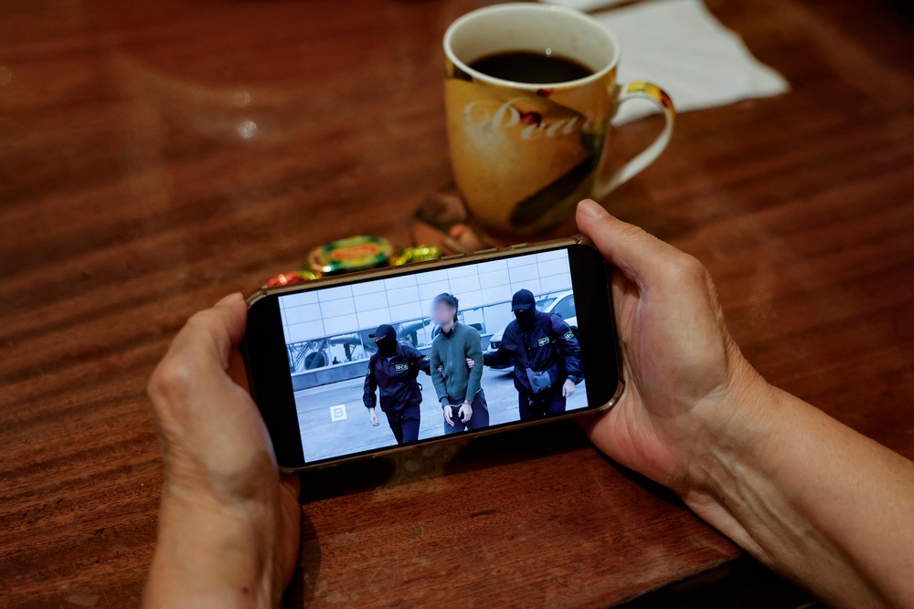 A person watches a news report about the detention of a Japanese journalist accused of espionage (AFP/Getty)