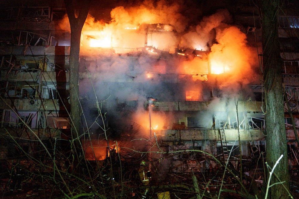A damaged multi-story residential building is seen on fire after a Russian missile strike on Kyiv, Ukraine, Tuesday, October 13 (AP)