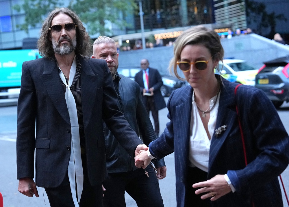 The pair hold hands as they head to court (AFP/Getty)