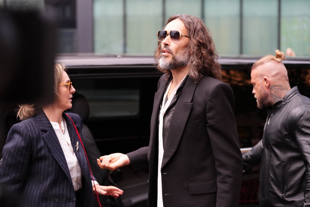 Russell Brand speaks to the media as he arrives at Southwark Crown Court, London (PA Wire)
