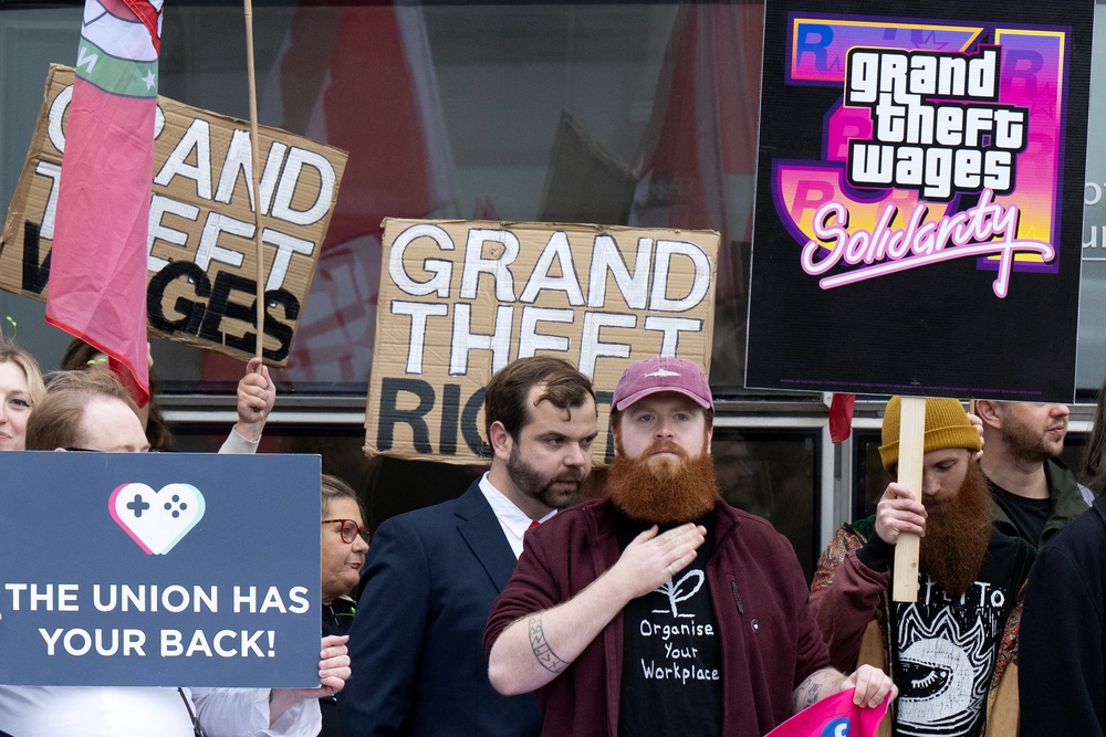 Protesters hold placards as they take part in a rally outside the Glasgow Tribunal Centre as representatives from Rockstar Games, the publisher of GTA VI (Grand Theft Auto), are expected at an employment tribunal in Glasgow (AFP/Getty)