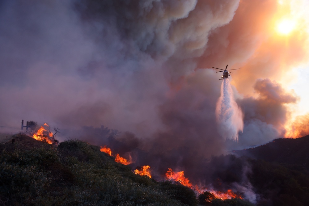 Water is dropped by helicopter on the advancing Palisades Fire in the Pacific Palisades neighborhood of Los Angeles, (AP)