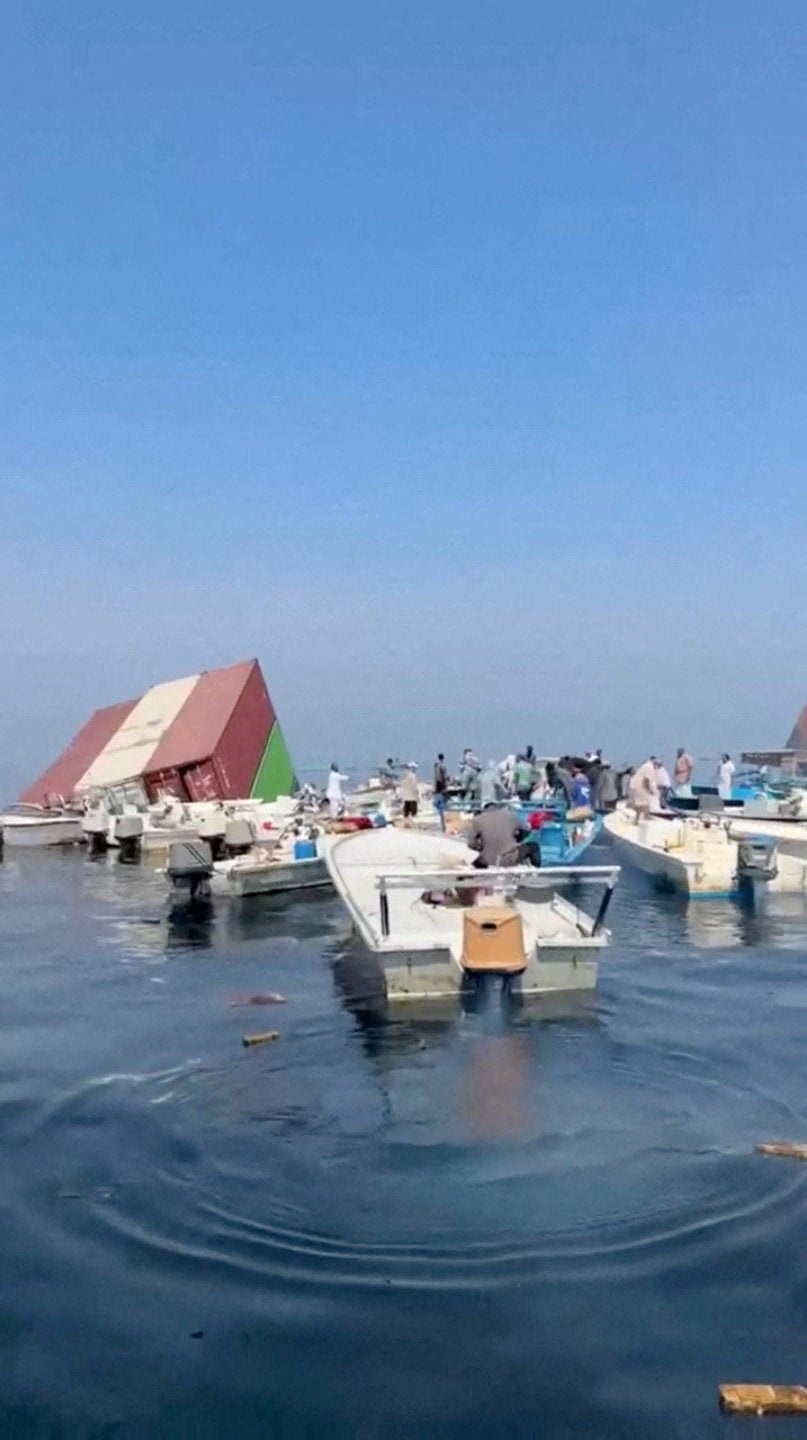 Containers float in the water after a vessel sank near the Strait of Hormuz off the coast of Oman, in this still image obtained from a social media video, released October 14, 2026. (Social media)