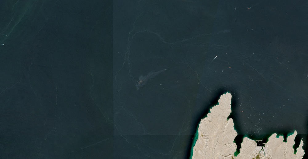 A satellite image shows containers and items floating in the water after a vessel sank near the Strait of Hormuz, off the coast of Oman, October 14, 2026 (European Union/Copernicus Sentinel-2)