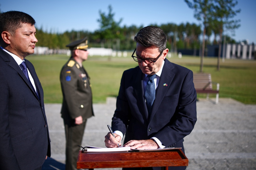Prime Minister Andy Burnham signs the visitors’ book after taking part in a wreath-laying at Ukraine’s national military memorial cemetery in Hatnem southwest of Kyiv, during his first foreign trip as PM (Henry Nicholls/PA)
