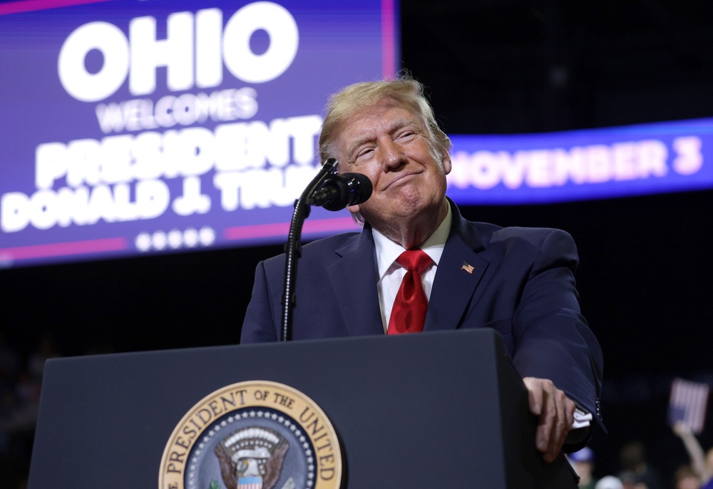 'I'm standing over here, and I don't do this with men very often. I started examining his body because I didn't know he was a great athlete, and I looked, and I watched up and down,' Trump said of Husted, a former college football player, at a rally Monday night in Youngstown, Ohio (Getty Images)