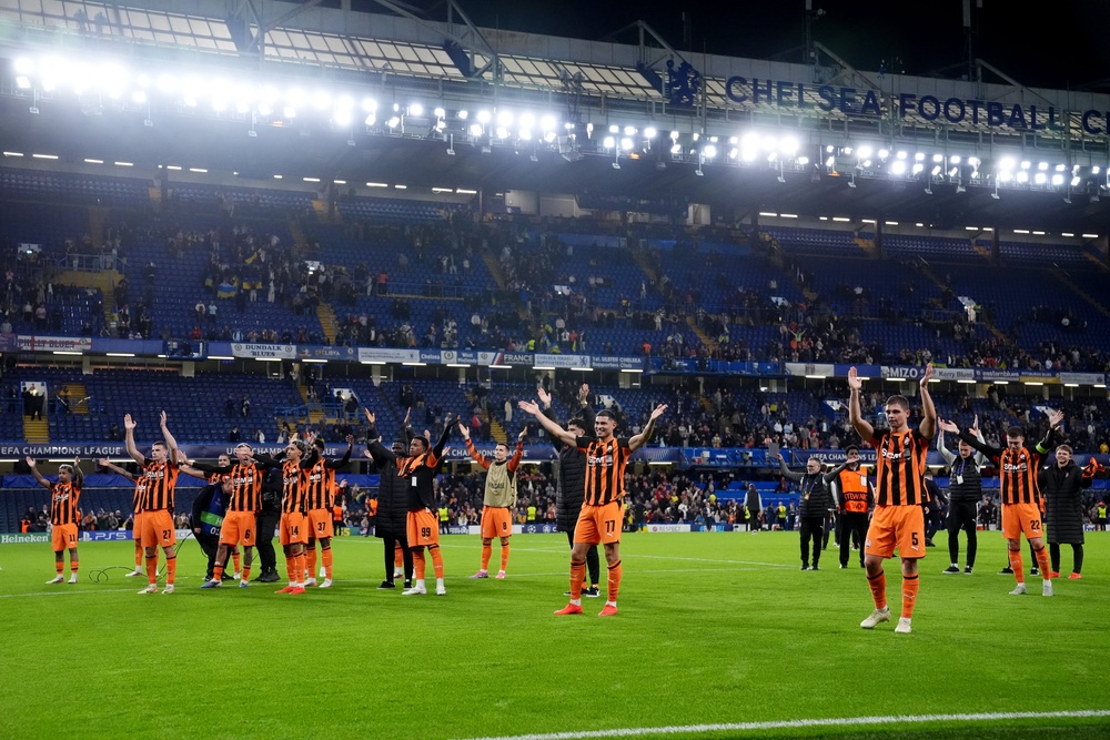Shakhtar players lead a 'Viking Thunder Clap' celebration with their supporters after their victory (PA)