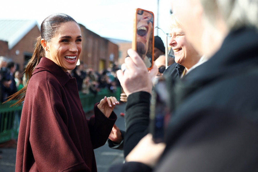 Meghan smiled for photographs and chatted to schoolchildren (Reuters)