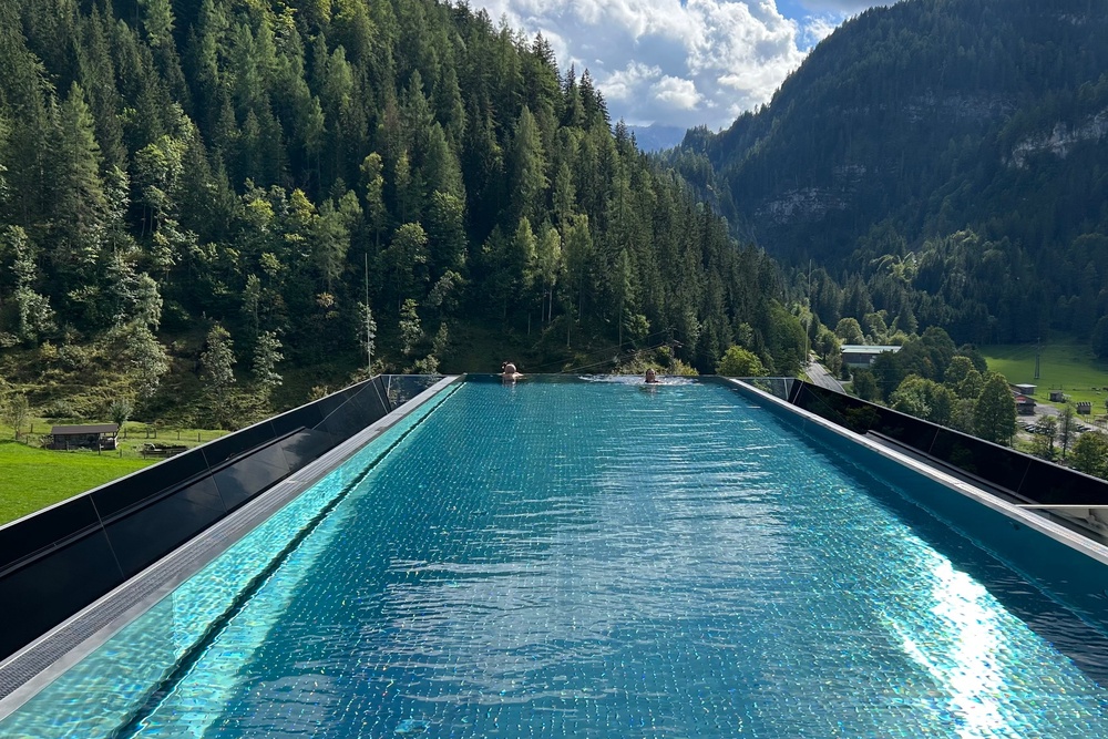 The jewel in the crown is the 20-metre infinity pool perched on the roof of the building, offering unparalleled views of the mountains (Caroline Gammell/The Independent)