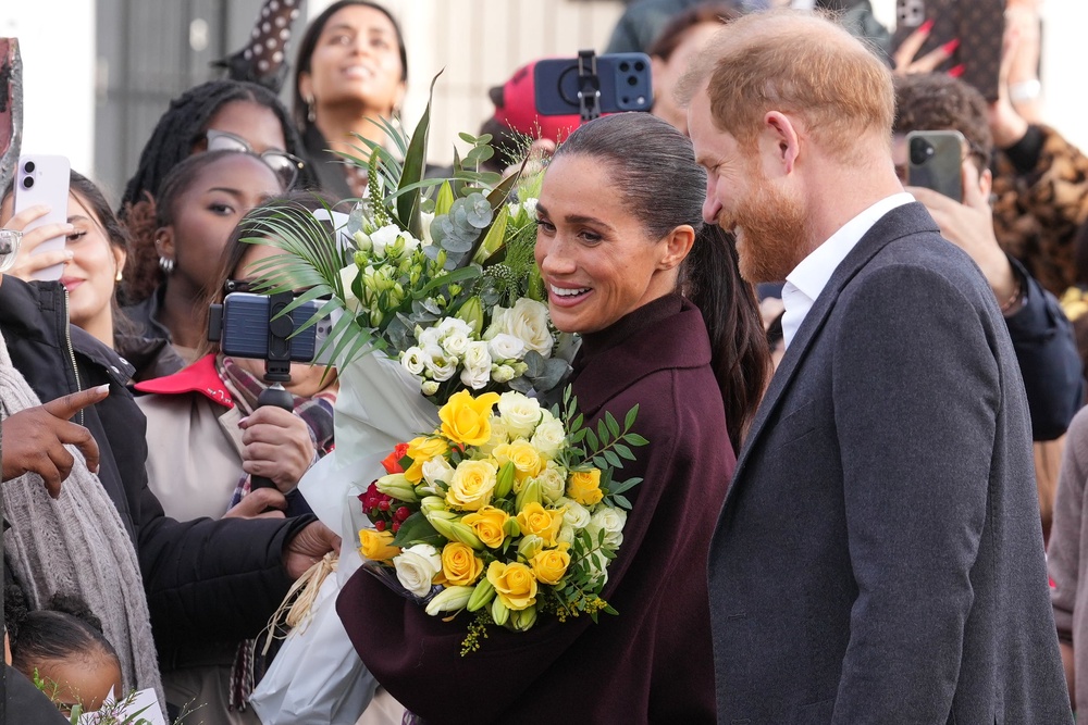 Meghan handed a bouquet of flowers upon her arrival in Nottingham (AP)