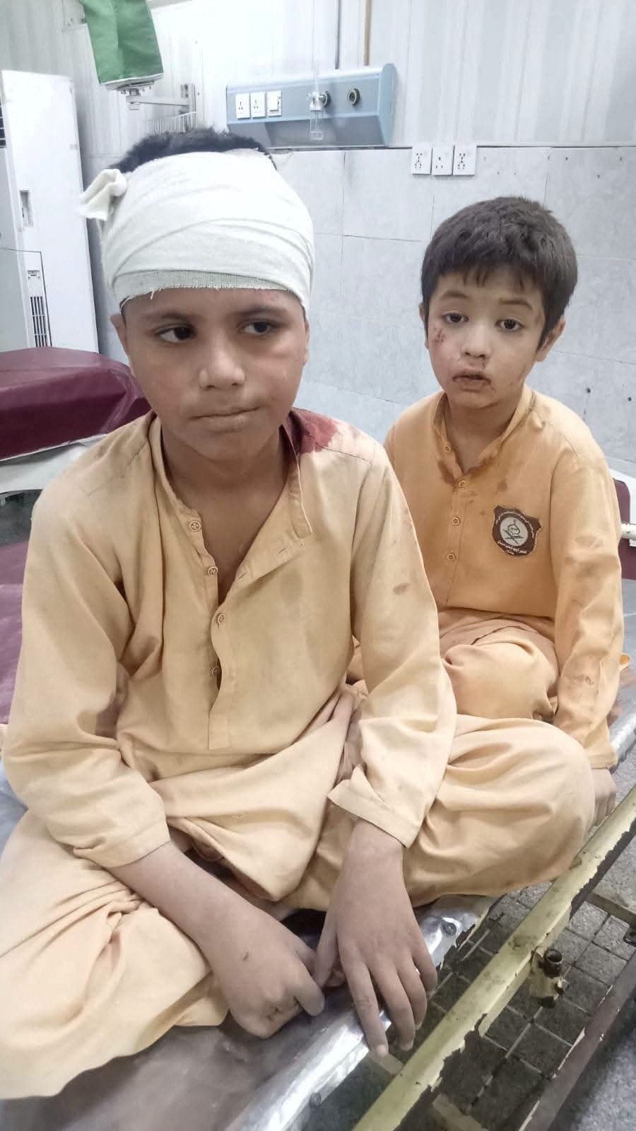 Students who were rescued after a school roof collapse receive first aid at a hospital in Peshawar (Reuters)