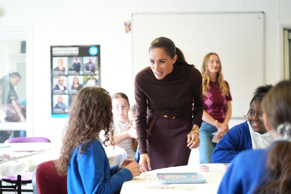 Meghan pictured chatting to children at the Community Recording Studio (Getty)