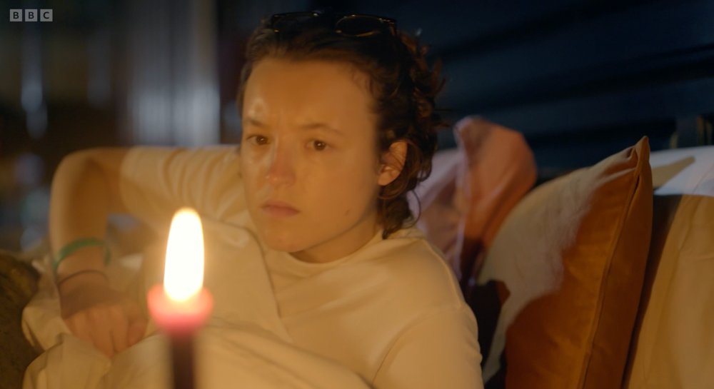 Bella Ramsey extinguishes their bedtime candle like a Victorian (BBC)