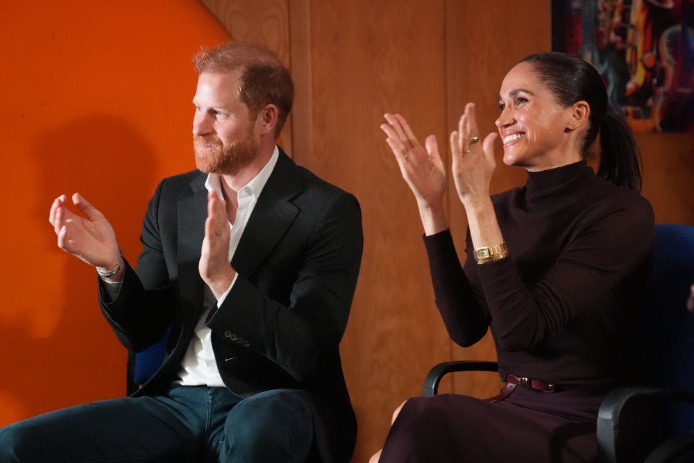 Harry and Meghan applauding after hearing Amelia Faith Currie sing (Joe Giddens/PA) (PA Wire)