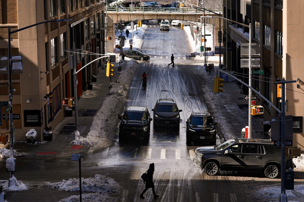 Pedestrians and cars pass through the Dumbo neighborhood of Brooklyn borough of New York, Feb. 24, 2026 (AP Photo/Yuki Iwamura)