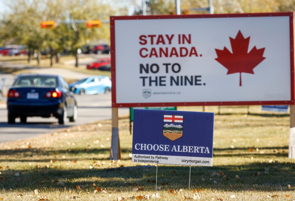 Competing referendum signs line a boulevard in Calgary (AP)