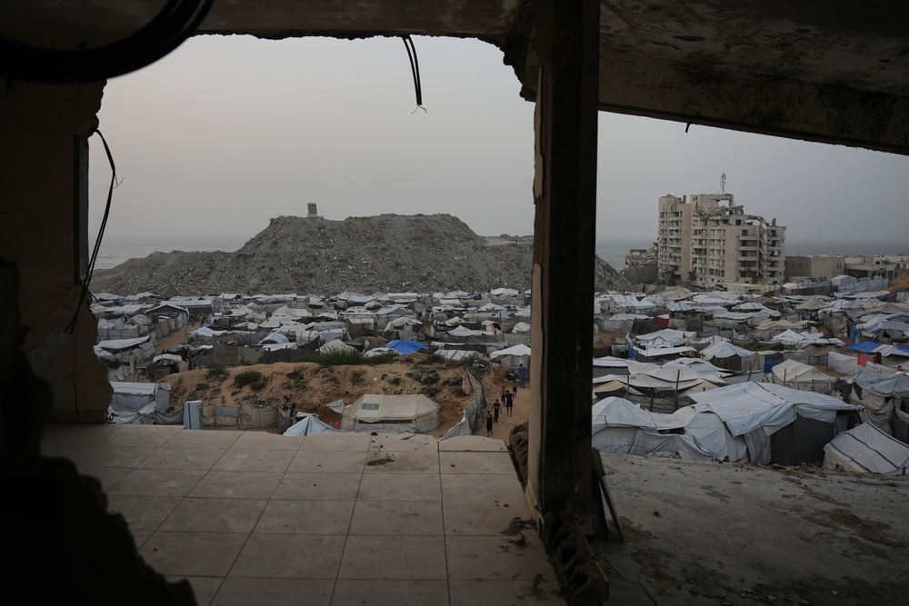 Palestinians walk among tents at a tent camp for displaced people in Gaza City, Friday, Oct. 16, 2026. (AP Photo/Abdel Kareem Hana) (Copyright 2026 The Associated Press. All rights reserved.)