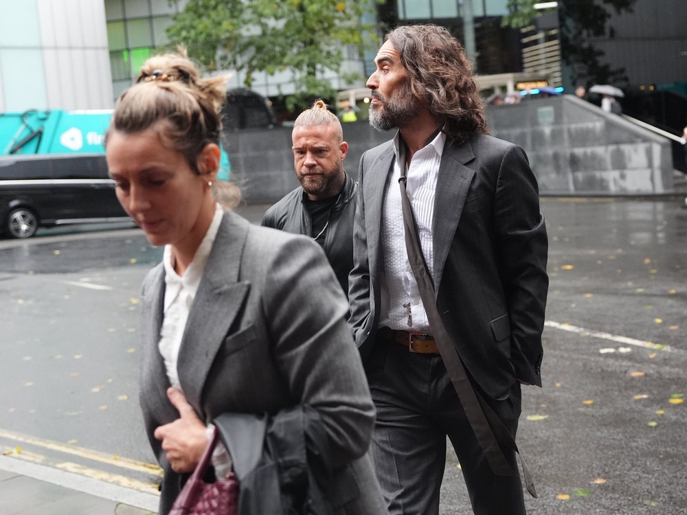 Russell Brand, accompanied by his wife Laura Gallacher, arriving at Southwark Crown Court (PA)