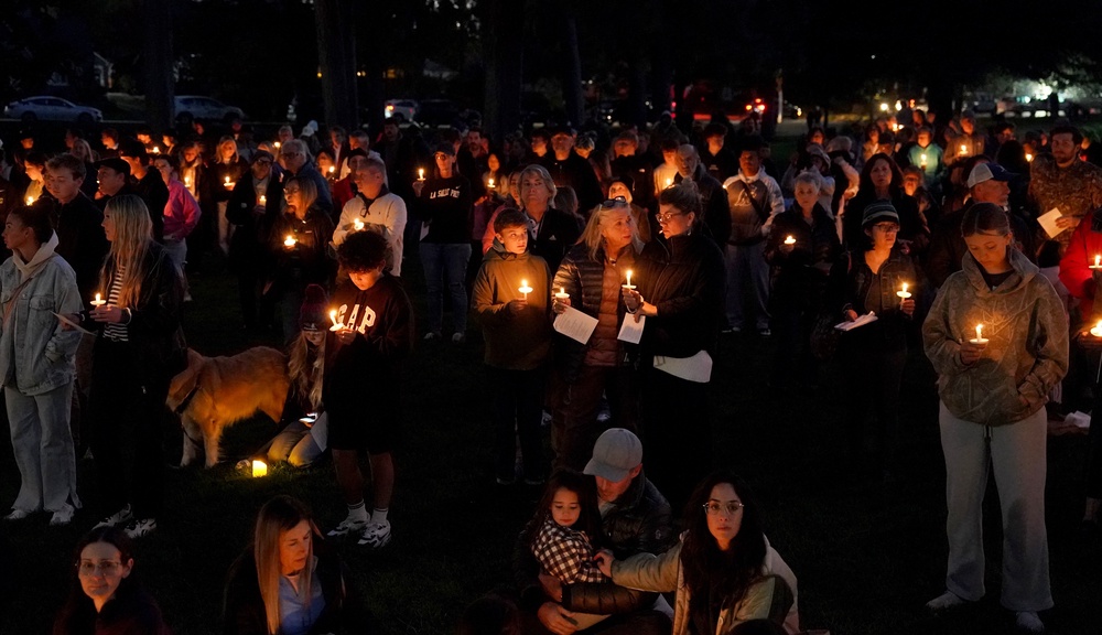 People gather for a candlelight vigil held in Drake Park in Bend, Oregon, following a shooting at Silver Rail Elementary School earlier in the day (AP)