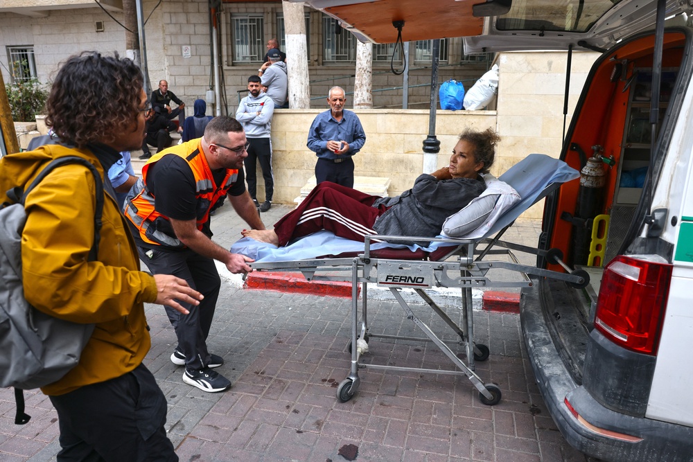 American freelance photojournalist Heidi Levine is transferred on a stretcher into a Palestinian ambulance from the government hospital in the Israeli-occupied city of Ramallah before she is handed over to an Israeli ambulance at a checkpoint for onward transport to a hospital in Tel Aviv (AFP/Getty)
