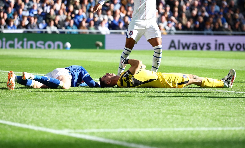 Martinez and Everton's Branthwaite on the ground after the collision (Reuters)