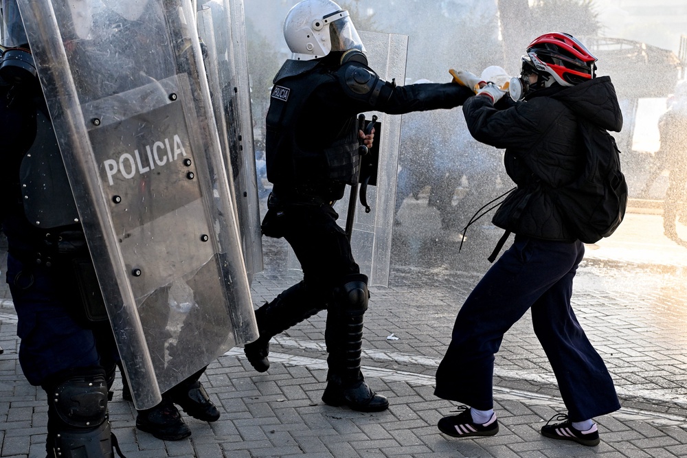 A protester clashes with a police unit during an anti-government demonstration in central Tirana (AFP/Getty)
