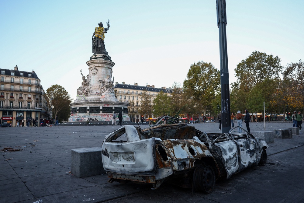 A destroyed car near the Marianne statue at the Place de la Republique in Paris (Reuters)