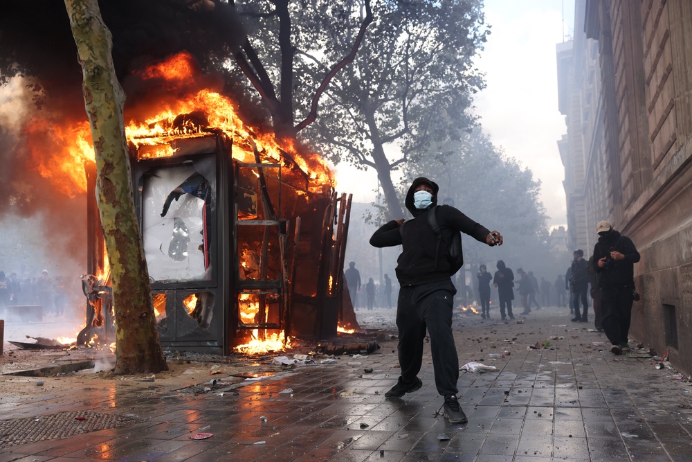 Protesters at Place De La Republique in Paris, set a fire during a march against rising living costs (PA)