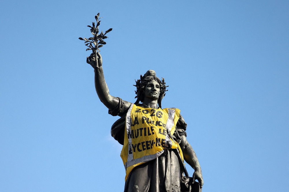 The Monument a la Republique, representing Marianne, with a yellow vest, the day after clashes during a national day of demonstrations (Reuters)