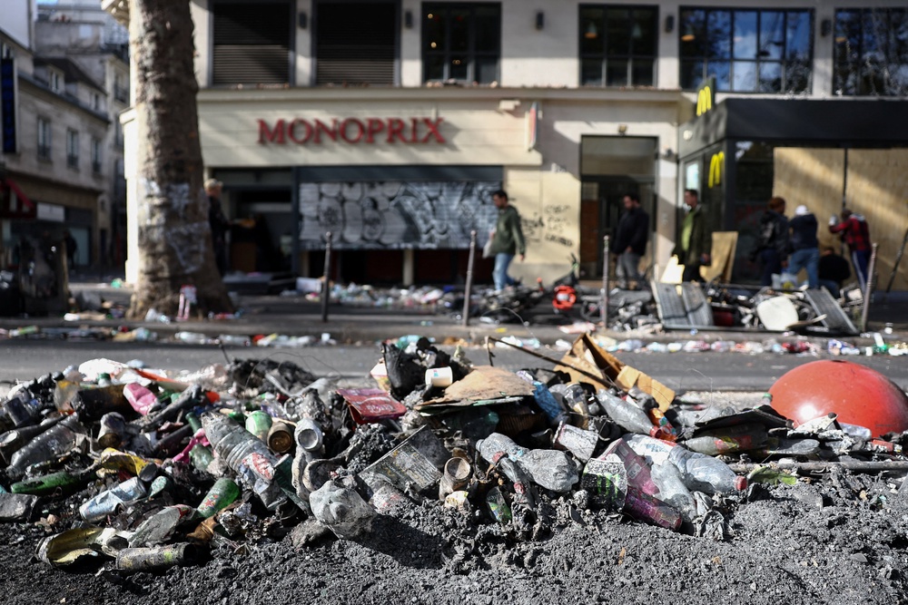 Ashes and rubbish on the side of a street, the day after clashes during a national day of demonstrations (Reuters)