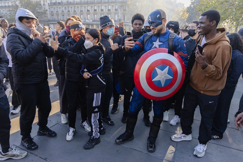 A protester dressed as Marvel superhero Captain America surrounds other protesters at Place de la Republique during another day of tensions following the national demonstration (AFP/Getty)